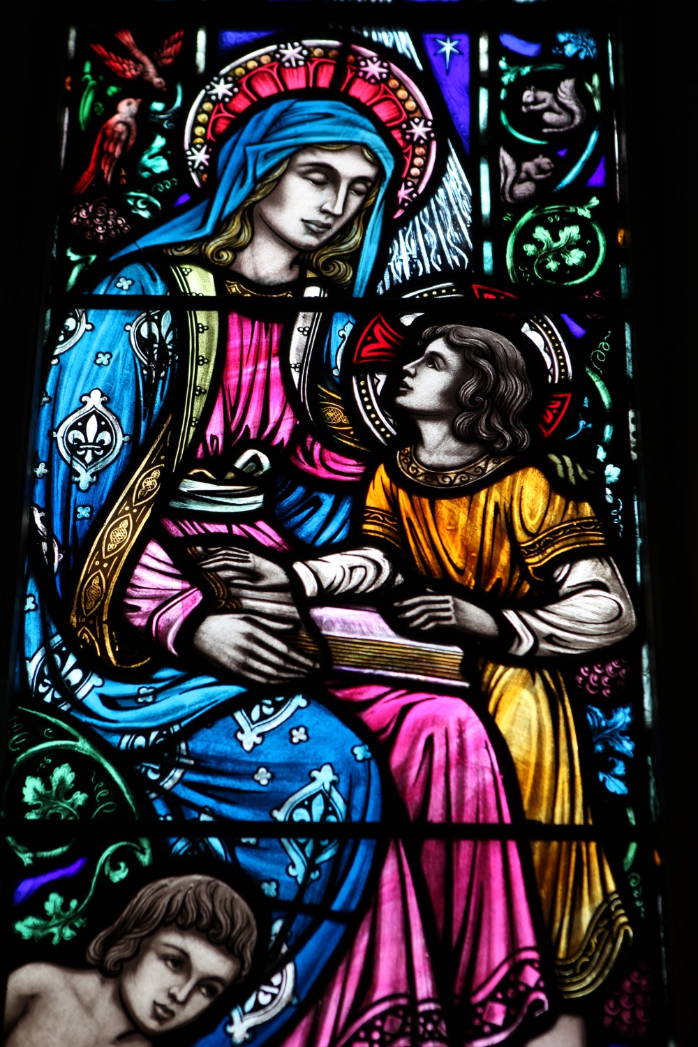 Detailed close-up of a stained glass window showing craftsmanship and paint quality